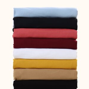 A neatly stacked assortment of colorful fabric swatches on a plain background.