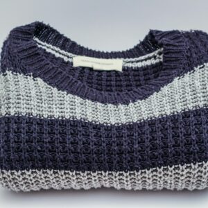 Warm knitted sweater with blue and white stripes, perfect for winter fashion.